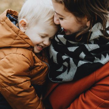 A mother holding her young son with albinism.
Photo by Tomáš Hudolin